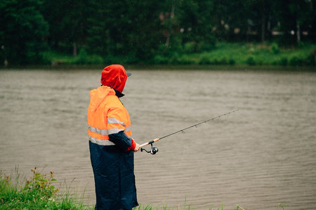 fisherman is fishing in the rain