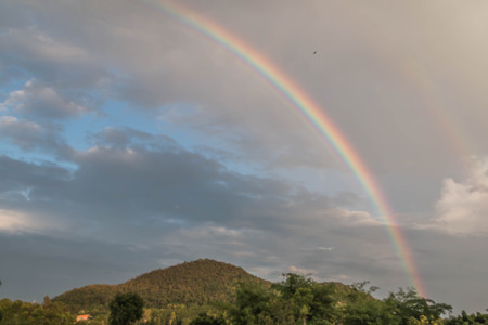 Rainbow is a natural phenomenon which occurs after rain. The emergence of sunlight through water droplets in the air. Make light of different colors caused by refraction. Therefore, a different stripeの写真素材