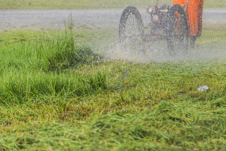 Mowing the lawn, cleaning the park or a place overgrown with grass. To keep the place clean, empty livable and more attractive.の写真素材