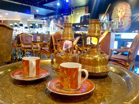 BANGKOK, THAILAND - JUNE 16, 2018 : The Fortune teller Egyptian Style black coffee set comprise of brass alcohol pots , jars  and cups in the Egyptian cafe.のeditorial素材