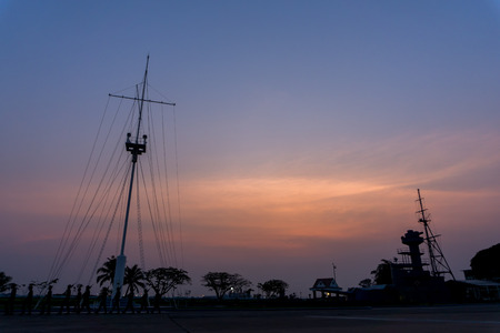 Silhouette view of navy style flag pole and maritime historic park.