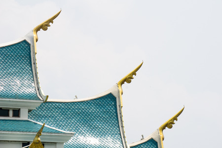 Small finials jutting out of the side â€“ corners of the blue gable roof, representing the...
