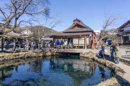 YAMANASHI, JAPAN - JANUARY 6, 2018 : Main house and clear spring water pond in Oshino Hakkai Village a small village in the Fuji Five Lake region, located between Lake Kawaguchiko and Lake Yamanakako.のeditorial素材