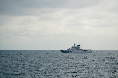 PADANG,INDONESIA - APRIL 16, 2016 : KDB Daruttaqwa (OPV-09) , Royal Brunei Navy Offshore Patrol Vessel sails in the sea to Padang for participating in Multilateral Naval Exercise Komodo 2016.のeditorial素材