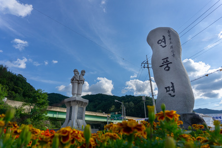 CHUNGCHEONGBUK, SOUTH KOREA - SEPTEMBER 25, 2018: Soldiers rock statue and Korean language craving monolith at the roundabout near Haengchon crossroads bicycle certification center in Yeonpung-myeon.のeditorial素材