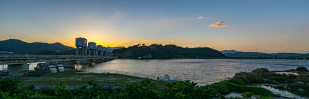 GYEONGSANGBUK-DO, SOUTH KOREA - SEPTEMBER 30, 2018: Panorama of the sunset scene of Chilokbo Dam across the Nakdong River in South Koreaのeditorial素材