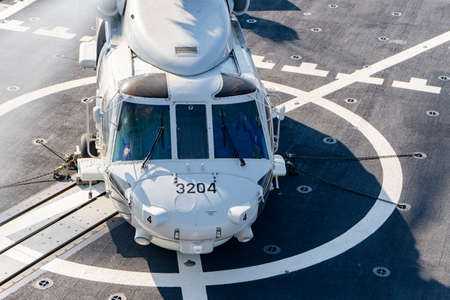 PHUKET, THAILAND - APRIL 9, 2019:  Sikorsky MH-60S Seahawk helicopter lands on the flight deck of the HTMS. Bhumibol Adulyadej  stealth frigate of Royal Thai navy  prepare for take off.のeditorial素材
