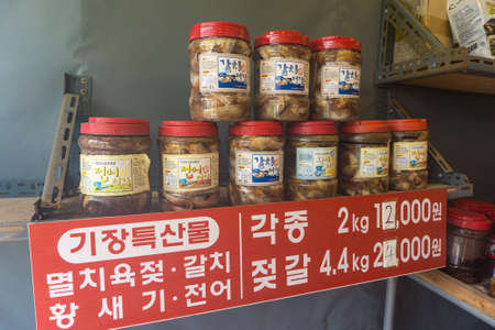 BUSAN, SOUTH KOREA - JULY 20, 2017 : Plastic cans of traditional Korean anchovy or fermented fish for sell in the local shop.のeditorial素材
