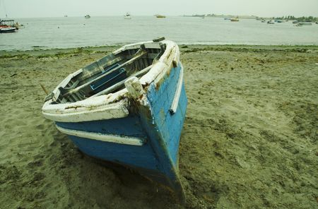 Blue boat in on the Pacific ocean coastの写真素材