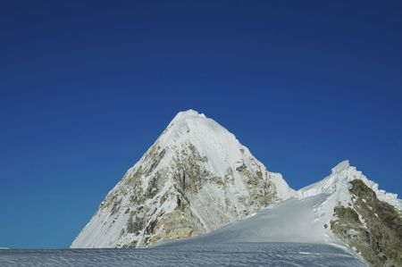 Snowcowered high cordillera mountain and cloudsの写真素材