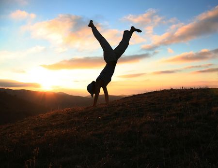 Cartwheel on the grassland on sunset backgroundの写真素材
