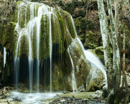 Beautiful small waterfull in green stoneの写真素材