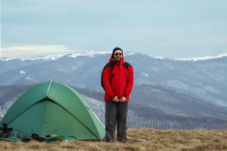Green tent and man on red jaketの写真素材