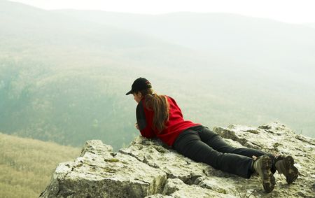 Girl overview landscapes on rockの写真素材