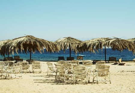 Beach scenery-umbrellas and chaurs on sand coastlinesの写真素材
