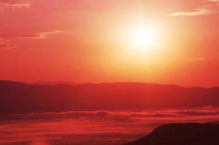 Sunset in misty mountainの写真素材