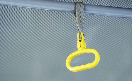Yellow handhold in bus