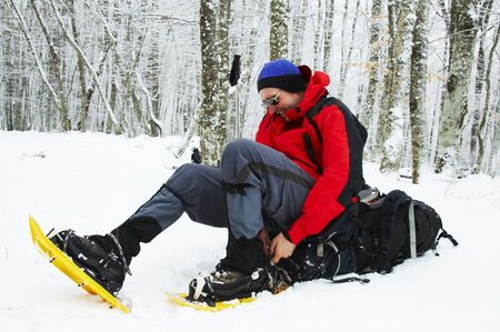 Climber in snowy forestの写真素材