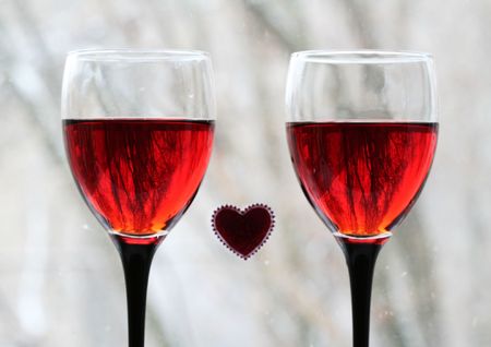 Two Wineglasses and heard on windowの写真素材