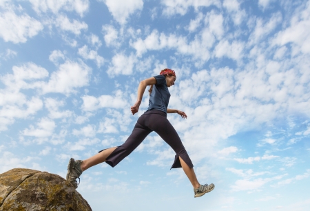 Girl jump from the rockの写真素材
