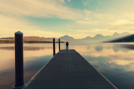 Man on mountains lakeの写真素材