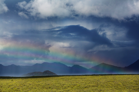 Rainbow above mountains, Alaskaの写真素材