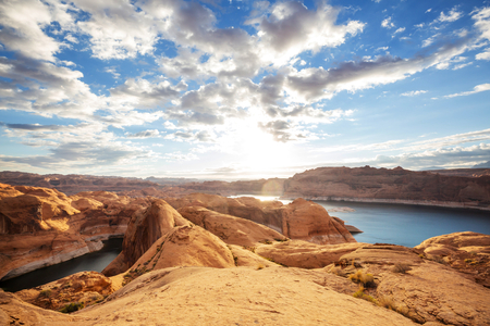 Unusual natural background. Reflection Canyon on Lake Powell, Utah, USA. Inspiring hiking scene-man resting on the beautiful sunset point.の写真素材