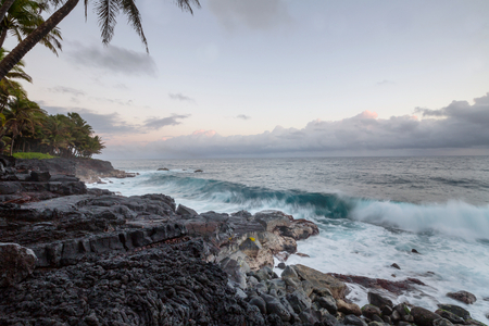Amazing beach. Wave in ocean at sunset or sunrise with surfer.の写真素材