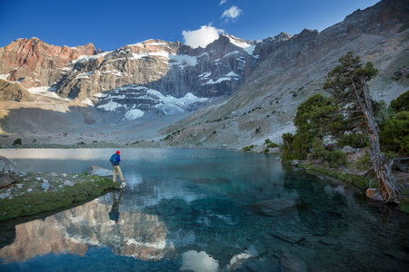 Wanderlust time. Man hiking in beautiful Fann mountains in Pamir, Tajikistan. Central Asia.の写真素材