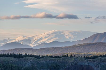 Picturesque Mountains of Alaska in summer. Snow covered massifs, glaciers and rocky peaks.