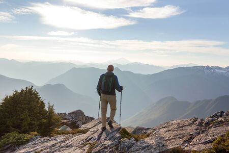 Backpacker in a hike in the summer mountains