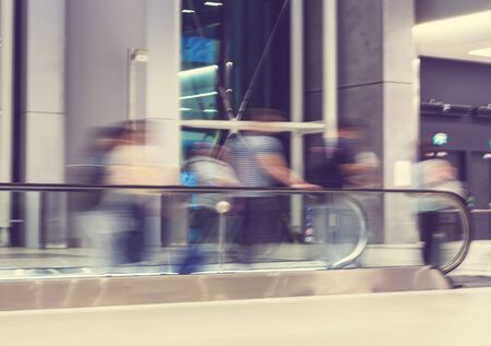 Moving escalator in airport terminal with motion blur