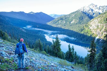 Backpacker in a hike in the summer mountains