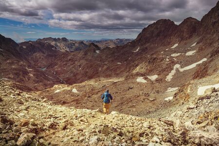 Backpacker in a hike in the summer mountainsの写真素材
