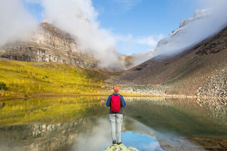 Hiking man in Canadian mountains. Hike is the popular recreation activity in North America. There...