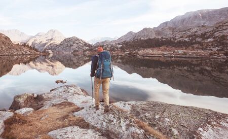 Backpacker in a hike in the summer mountains