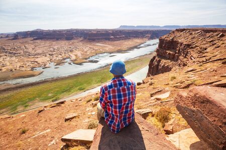 Man on the mountains cliff. Hiking scene.