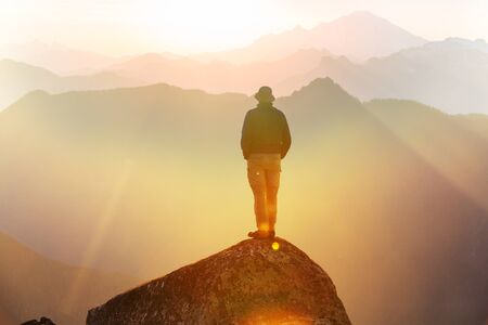 Man on the mountains cliff. Hiking scene.