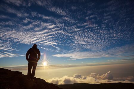 Backpacker in a hike in the summer mountains