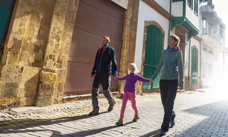 Family walking on the street in old european townの写真素材