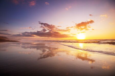 Scenic colorful sunset at the sea coast. Good for wallpaper or background image. Beautiful nature landscapesの写真素材