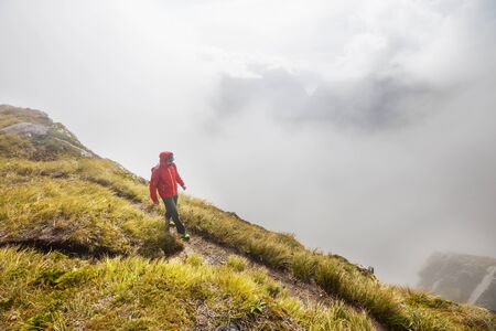 Backpacker in hike in the autumn mountains