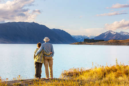 couple in beautiful mountains lake, New Zealand, Tekapo lakeの写真素材