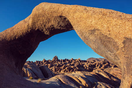 Hiker in unusual stone formations in Alabama hills, California, USAの写真素材