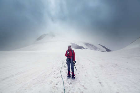 The climb in high snowy mountainsの写真素材
