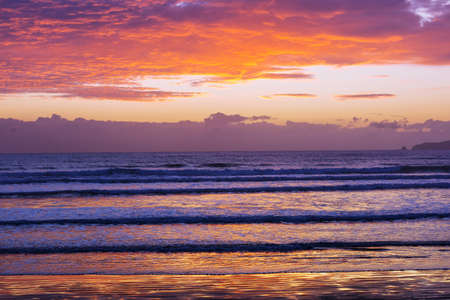 Scenic colorful sunset at the sea coast. Good for wallpaper or background image. Beautiful nature landscapesの写真素材