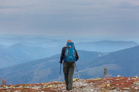 Backpacker in hike in the high mountains
