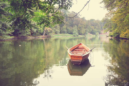 Boat on lake in autumn parkの写真素材
