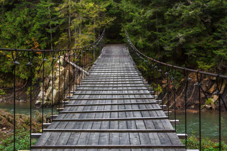 Wooden bridge over a mountains creek