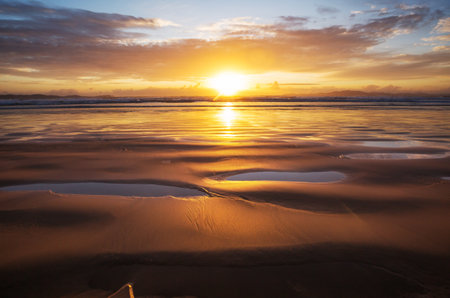 Scenic colorful sunset at the sea coast. Good for wallpaper or background image. Beautiful nature landscapesの写真素材